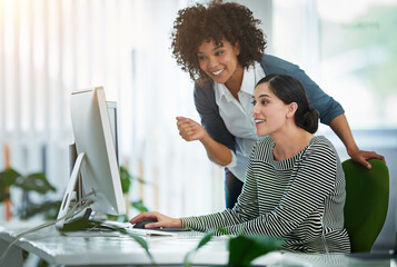 Poster - Sharing a laugh in the office. Shot of designers talking together at a workstation in an office.
