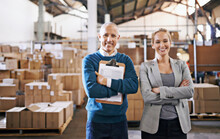 Your Shipment Is In Capable Hands. Portrait Of Two Managers Standing In A Distribution Warehouse.