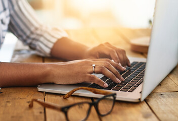 Poster - I have some to blog about. Cropped shot of a woman using her laptop on a wooden table.