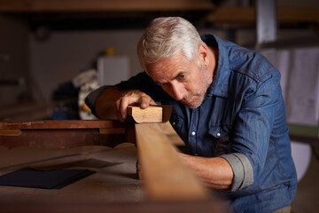 Canvas Print - Woodwork pro. Shot of a mature male carpenter working on a project in his workshop.