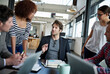 © Yuri A/peopleimages.com - Putting their heads together. Shot of office workers talking in a meeting in an office.