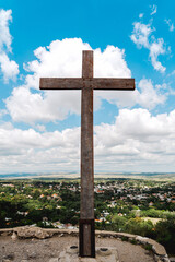 Sticker - A vertical shot of a big metal cross on the top of the hill