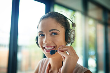 Wall Mural - Your business is important to us. Shot of a young woman working in a call center.