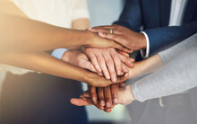 Work Together, Win Together. Cropped Shot Of A Team Of Colleagues Joining Their Hands Together In Unity.