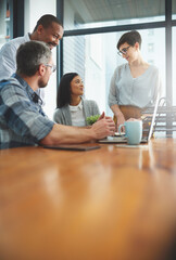 Sticker - Working together to get the task done. Shot of businesspeople working together in the office.