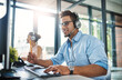 © Arnéll Koegelenberg/peopleimages.com - Theyve got the answers youre looking for. Cropped shot of a handsome young man working in a call center with a female colleague in the background.