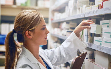 Poster - Pharmacists improve medication adherence. Shot of a pharmacist looking at medication on a shelf.