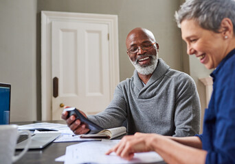 Poster - Financial planning has done them the world of good. Cropped shot of a senior couple working on their finances at home.