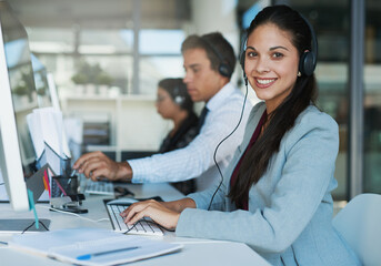 Aufkleber - Happy to hear from you. Portrait of a happy and confident young woman working in a call center.