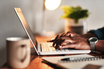 Canvas Print - The hard work never ends. Cropped shot of an unrecognizable businessman sitting alone in his home office and working on his laptop.