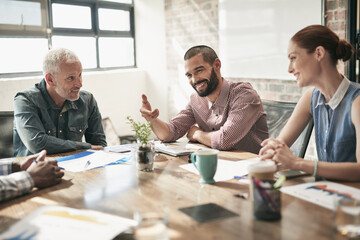 Aufkleber - Hes a good team player. Shot of a team of businesspeople having a meeting in an office.