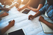 © Delmaine Donson/peopleimages.com - Bringing the best in the business together. Cropped shot of a group of architects working together on a project.