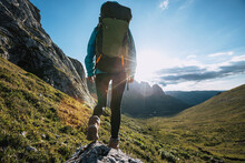 Solo Woman Backpacker Hiking On Alpine Mountain Peak
