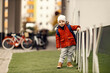 © Dusan Petkovic - A playful three year old child with schoolbag on his back ready for kindergarten standing outdoors.