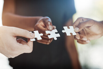 Poster - There is no solution greater than teamwork. Cropped shot of a work group connecting pieces of a puzzle.