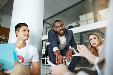 Wall Mural - No idea goes unshared. Shot of a group of colleagues having a brainstorming session in a modern office.