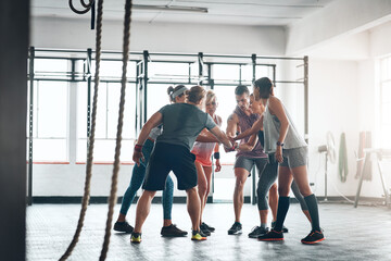 Poster - were in this together. shot of a fitness group working out at the gym.