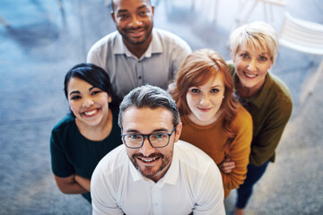 Aufkleber - Working together to move on up. High angle portrait of a team of colleagues standing together in a modern office.