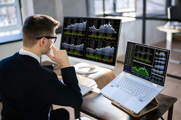 Poster - Young Male Stock Market Broker Looking At Graph On Computer