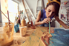 A Young Female Artist Is Using Different Techniques While Working On A New Painting At The Studio. Art, Painting, Studio