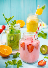 Wall Mural - Healthy fresh fruit and berry smoothies in glass jars. Summer cold drinks