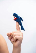 Boy Playing Finger Toy Figure Of Animal. Shark Figure  Put On Finger Of Child Hand, Puppet Theatre.