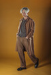 © qunica.com - Portrait of a smart young man standing against yellow backgroun