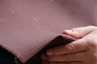 © Ganna Zelinska - Male hand with sandpaper. Copy space.
