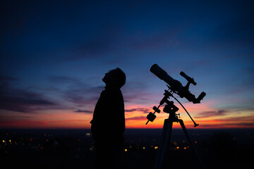 Wall Mural - silhouette of a man, telescope and countryside under the starry