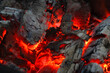 canvas print picture - Smoldered logs burned in vivid fire close up. Atmospheric background with flame. Background from a fire, conflagrant firewoods and coals