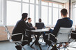 © xartproduction - Group of young business people working and communicating while sitting at the office desk together with colleagues sitting. business meeting