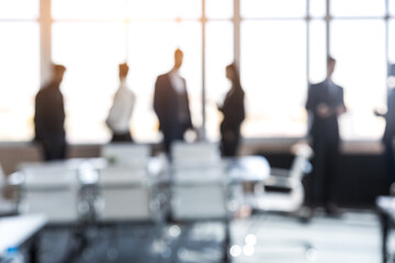 Wall Mural - Silhouettes of people against the window. A team of young businessmen working and communicating together in an office. Corporate businessteam and manager in a meeting. Blured image.