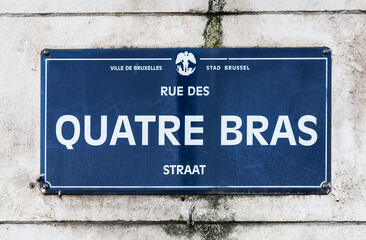 City of Brussels / Belgium - Streetname tag on a brick facade of the Quatre Bras square, the court house district