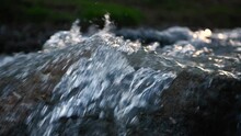 Slow Motion Of Norwegian Mountain River , Stream Flowing Through Rocks. Close Up Of River Stones With Flowing Water, Clean Water Flowing In A Mountain River At The Norway