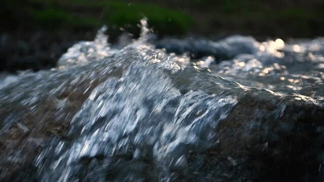 Fototapete -  - Slow motion of Norwegian mountain river , stream flowing through rocks. Close up of river stones with flowing water, clean water flowing in a mountain river at the Norway