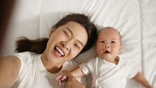 Point Of View, Young Asian Mother And Her Newborn Baby Selfies With Smile Via Video Call Or Facetime Feeling Happy