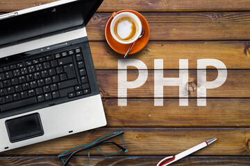 Poster - PHP Programming Language. Word PHP on wooden desk and laptop
