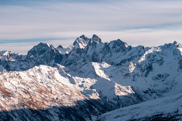 Wall Mural - Snowy mount Ushba. Greater Caucasus ridge. Sunny day. Before suset. View from russian side