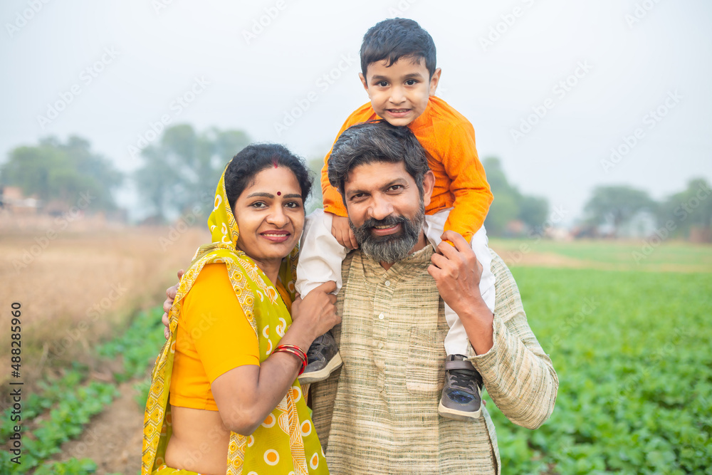 Portrait happy traditional Indian family at agricultural field, Smiling ...
