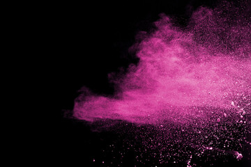 Pink powder explosion isolated on black background