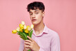 © Tatiana - portrait of a young man bouquet of flowers date romance posing pink background unaltered