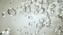 Moving Bubbles On Light Background, Macro Shot.
