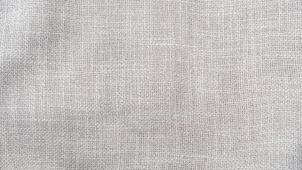 Wall Mural - jute hessian sackcloth woven burlap texture background in sepia cream old aged brown color