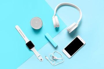 Modern gadgets with power bank on blue background