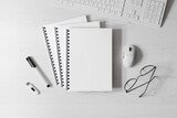 Three comb bound books on the table mockup
