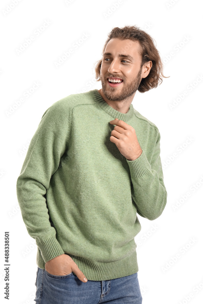 Handsome young man in knitted sweater on white background