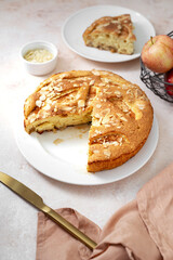 Sticker - Traditional apple pie on a white plate on a light culinary background. Charlotte pie on a platter closeup. Delicious homemade cakes on the kitchen table