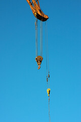 Ship crane hooks against the sky