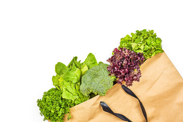 Fresh green leafy vegetables in the paper bag