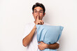 Young caucasian man wearing pajamas holding a pillow isolated on white background keeping a secret or asking for silence.